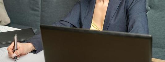 Businesswoman writing in a notebook photo