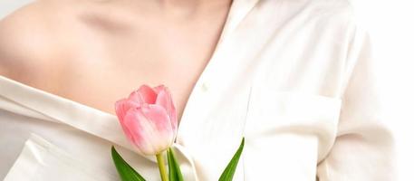 One pink tulip against young female photo