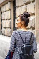 Young woman walks with backpack photo