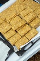 Assortment of cereal or protein bars that leave the assembly line at the factory. Healthy pre or post workout snacks with fruits, nuts and berries. photo