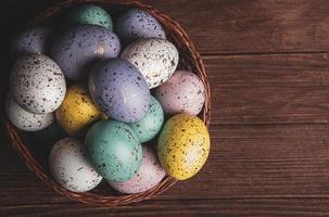 Pastel Easter eggs background. Spring greating card. Easter eggs in basket photo