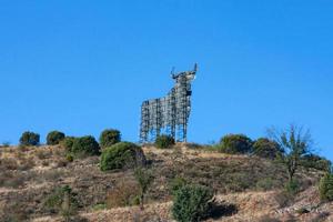 Sculpture of a bull on a hill against a blue sky, Spain, Catalonia photo