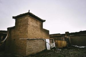 Abandoned adobe houses by the lakeside of Sailimu Lake photo