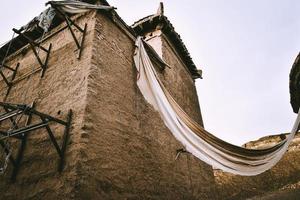 Abandoned adobe houses by the lakeside of Sailimu Lake photo