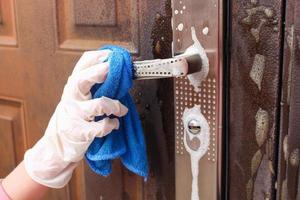 Person washes handle of the front door. photo