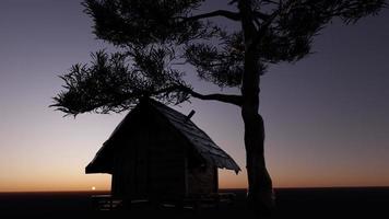 Cabin under the shade of a tree at a peaceful dawn photo