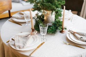 Beautiful table setting for Christmas dinner in Scandinavian style photo