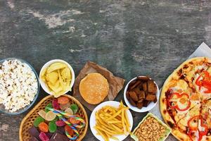 Fast food on old wooden background. Concept of junk eating. Top view. Flat lay. photo
