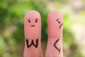 Fingers art of displeased couple. Woman was offended, man asks her forgiveness. photo