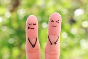 Fingers art of couple. Woman cries, man laughs. photo