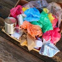 Box with trash on wooden background. photo