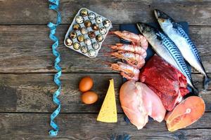 Healthy food of animal origin on old wooden background. Concept of proper nutrition.  Top view. Flat lay. photo