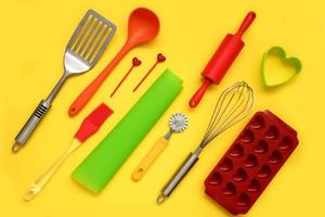 culinary silicone supplies arranged diagonally on a yellow background, culinary background photo
