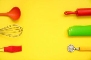 culinary background, on a yellow background, culinary utensils are laid out around the edges photo