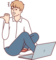 Man sitting on floor with laptop and looking back pointing finger doing online working png