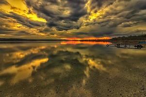 Stunning long exposure clouds with transparent water reflection photo
