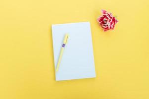 Creative flat photography desktop. Top view yellow desk with blank notebooks mockup with pencil photo