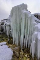 Beautiful big icicles over the old abandoned bridge photo