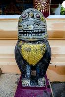 Buddhist sculptures at a temple in Bangkok, Thailand photo