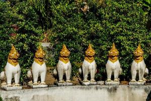 Buddhist sculptures at a temple in Bangkok, Thailand photo