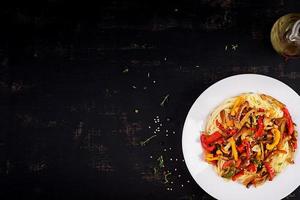 Noodles with shimeji mushrooms and paprika. Oriental meal. Japanese Shimeji mushroom stir fry. Top view photo