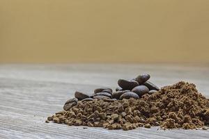 Close view of heaps of fine grinding coffee powder, coffee beans and instant coffee photo