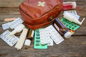 First aid kit on old wooden background. photo