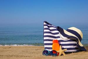 Summer women's accessories on the beach. photo