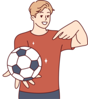 Young man holds soccer ball and points finger at it, offering to play football png