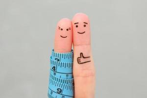 Fingers art of a Happy couple with tape measure. Concept of losing weight together. photo