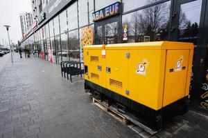 Yellow diesel generator on street. photo