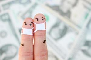 Fingers art of couple with face mask on background of money. photo