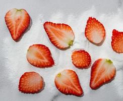 Strawberry protein powder and fresh strawberry fruit on white marble background. Top view. Flat lay photo
