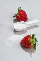 Natural strawberry collagen protein powder for skin regeneration in a scoop. Plant based. Hydrolyzed. The concept of food additives. photo