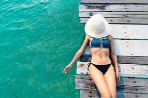 beautiful woman wearing bikini by the sea in summer photo