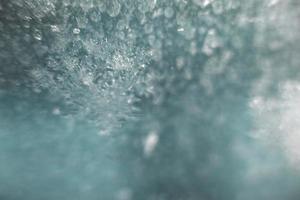 Blue abstract background. snow pattern on the glass from frost. dust on the window photo