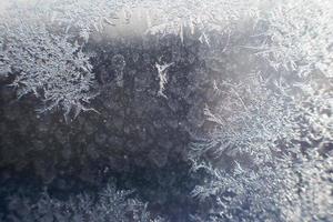 snow pattern on the glass from frost photo