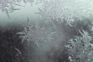 snow pattern on the glass from frost photo