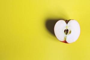 apple cut on a yellow background. half apple photo
