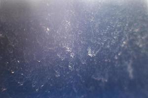 Blue abstract background. snow pattern on the glass from frost. dust on the window photo