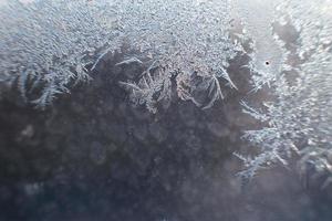 snow pattern on the glass from frost photo