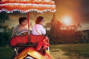 two woman riding on elephant walking in ayutthaya world heritage site of unesco one of most popular traveling destination in thailand photo