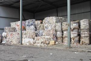 Wastepaper compact texture pile for recycling on sorting plant. Technology of reuse materials. Stack of shredded paper. Save the planet ecology concept. Industry of reduced pollution factory. Close-up photo