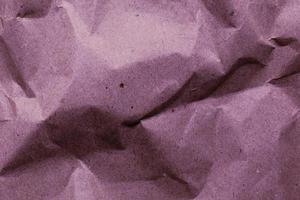 colored crumpled paper. Lilac purple background. Simple creative crumpled paper design. No text. photo