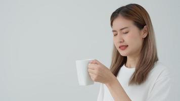 Asian woman feel sensitive teeth after drinking hot, female suffer tooth, decay problems, dental care, tooth extraction, decay problem, bad breath, Gingival Recession, Oral Hygiene instruction