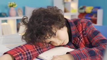 A boy who fell asleep while studying wakes up. Doing homework. The boy who fell asleep during the study suddenly gets up and returns to the beginning of his lessons. video
