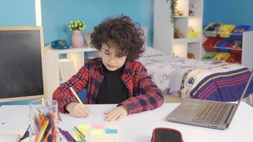Boy drawing picture. Creative and intelligent boy. Boy using his imagination draws a picture. video