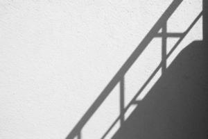 Banister Shadow on White Concrete Wall Texture Background in Minimal Concept. photo