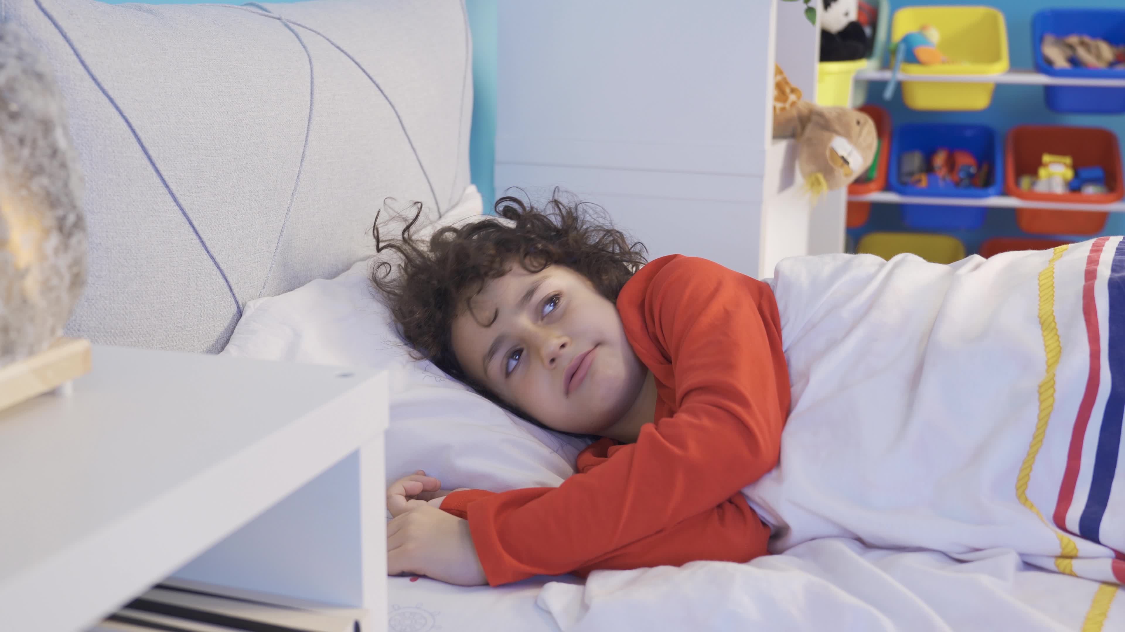 A boy with sleep problems can't sleep. Insomnia. The boy lying in the