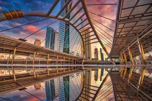 Modern structure bridge shape and building at sunset in train station, Bangkok, Thailand. photo